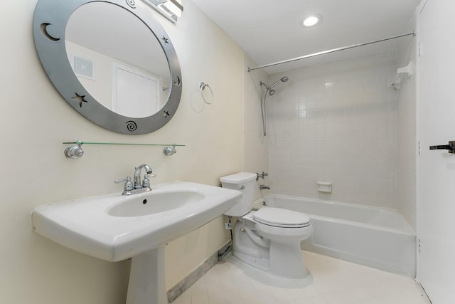 full bathroom featuring toilet, tiled shower / bath, and sink