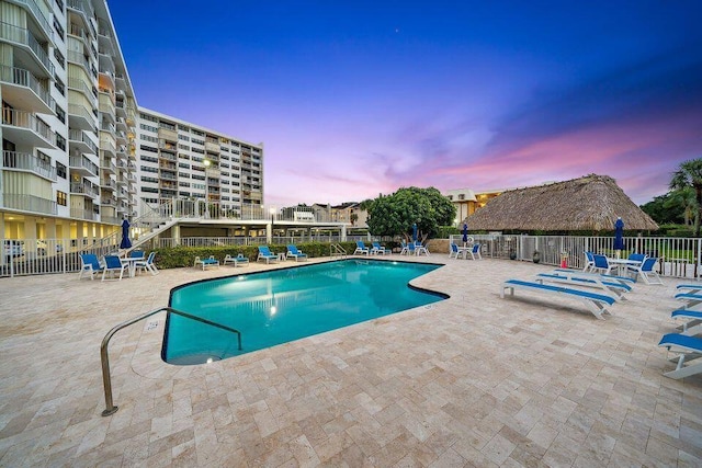 pool at dusk with a patio