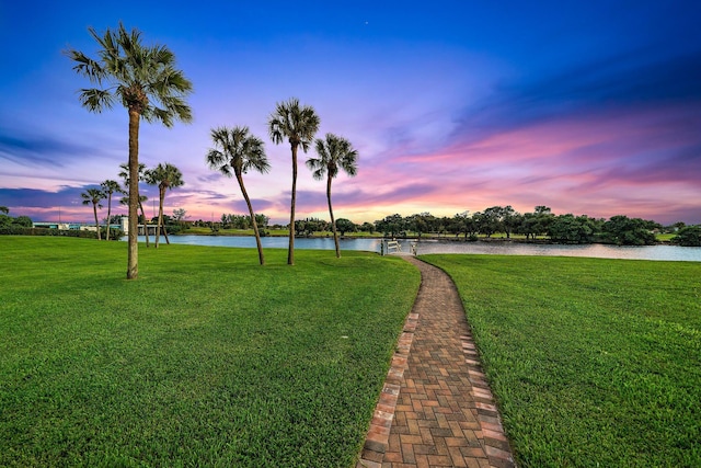 exterior space featuring a yard and a water view