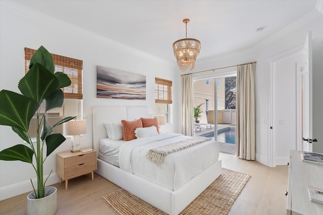 bedroom with a notable chandelier, ornamental molding, access to outside, and light hardwood / wood-style flooring