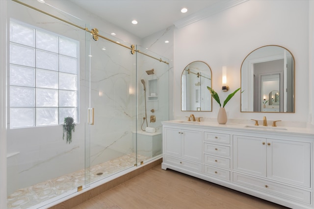 bathroom with hardwood / wood-style floors, vanity, and a shower with shower door