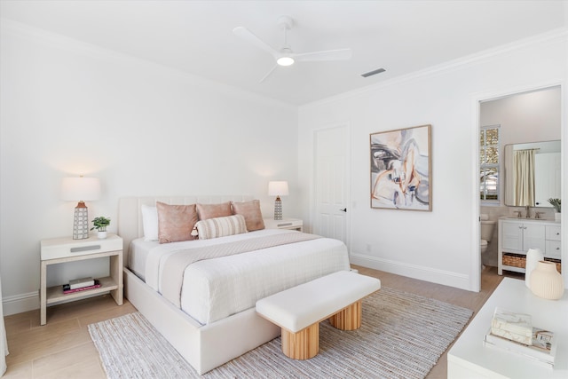 bedroom featuring ceiling fan, crown molding, sink, and connected bathroom