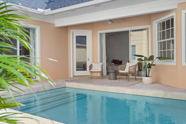 view of swimming pool featuring ceiling fan