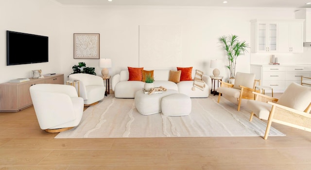 living room featuring light hardwood / wood-style flooring and crown molding