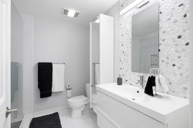 bathroom with tile patterned flooring, vanity, and toilet