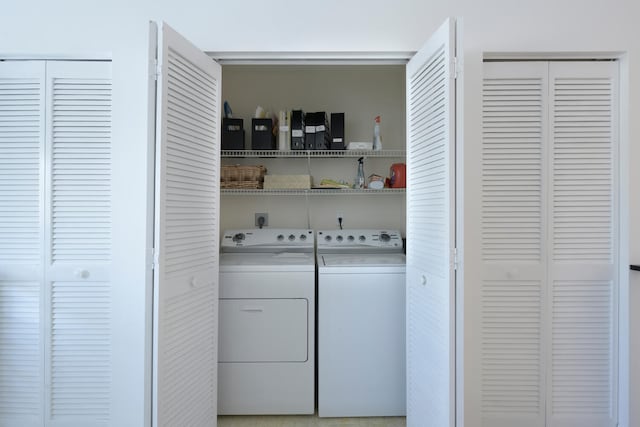 clothes washing area featuring washer and clothes dryer