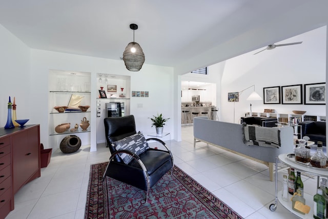 tiled living room featuring ceiling fan