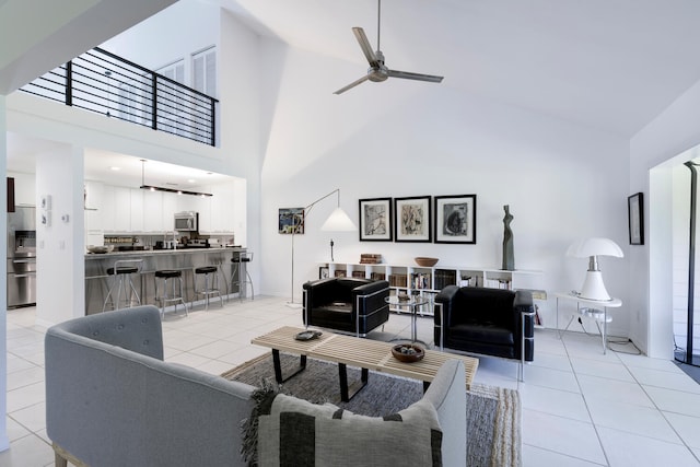 tiled living room featuring a high ceiling and ceiling fan