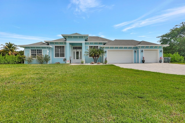 view of front of home with a garage and a front lawn