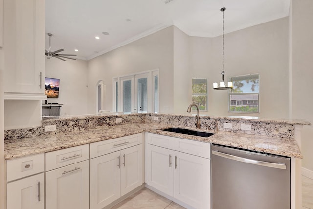 kitchen with ceiling fan, sink, light stone counters, stainless steel dishwasher, and crown molding