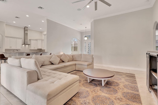 tiled living room featuring ceiling fan and crown molding