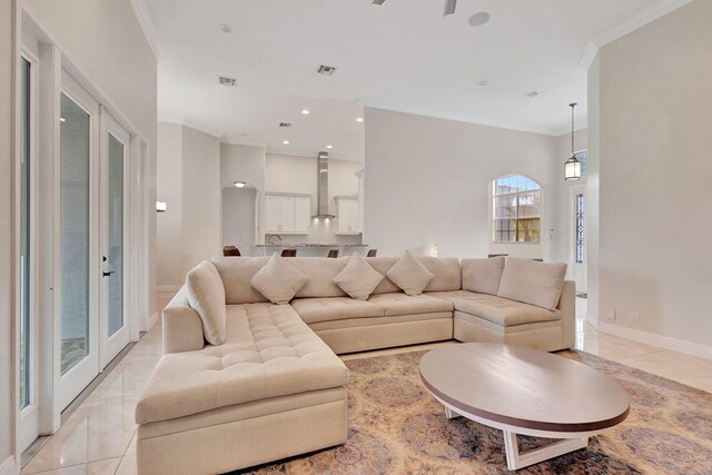 living room featuring visible vents, ornamental molding, and baseboards