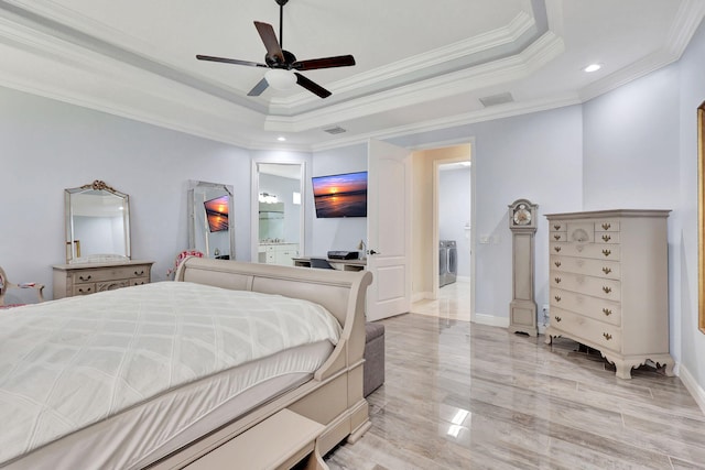 bedroom featuring a raised ceiling, washer / clothes dryer, ceiling fan, and ornamental molding