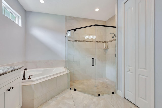 full bath featuring vanity, a shower stall, a bath, and recessed lighting