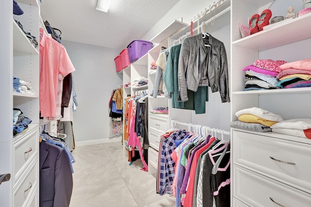 spacious closet featuring light tile patterned flooring