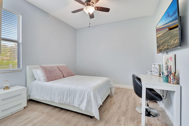 bedroom with ceiling fan and light hardwood / wood-style flooring