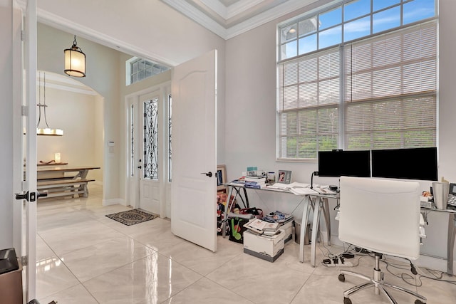 office area with a chandelier, plenty of natural light, crown molding, and arched walkways