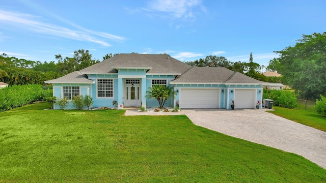 ranch-style house with a garage and a front lawn