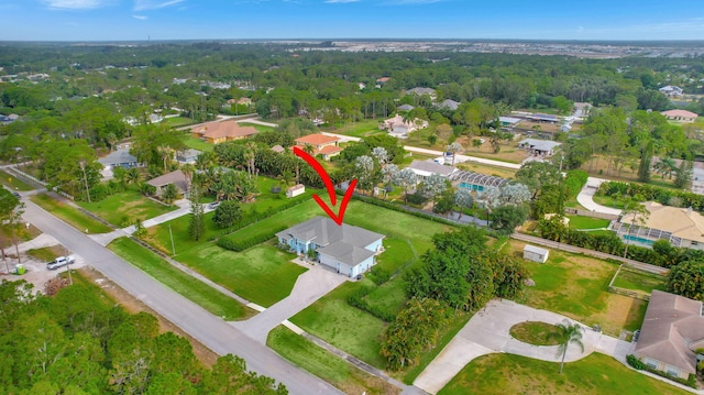 birds eye view of property featuring a wooded view