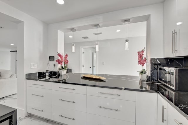 kitchen featuring white cabinetry and decorative light fixtures