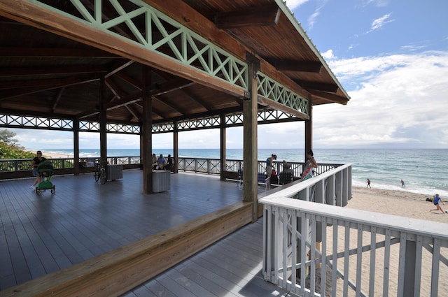 dock area with a view of the beach, a gazebo, and a water view