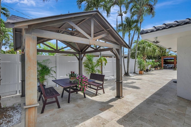 1001 W Palmetto Park Rd, Boca Raton, FL 33486 - view of patio featuring a fenced backyard, a gazebo, and outdoor dining space