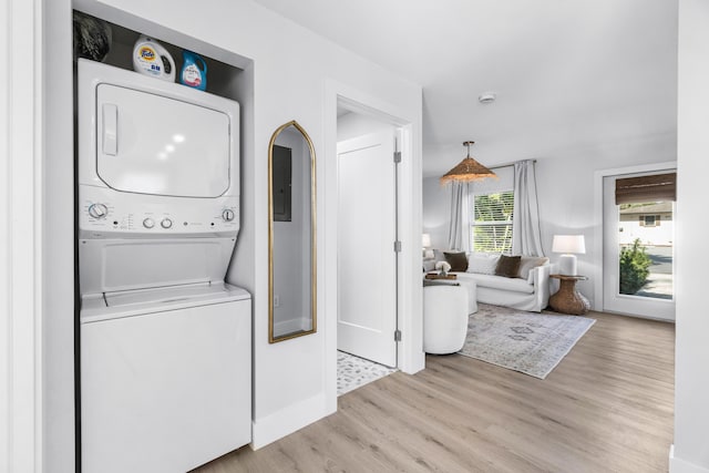 washroom featuring light wood-type flooring and stacked washer and dryer