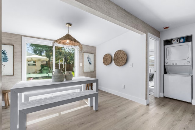 dining room featuring light hardwood / wood-style flooring and stacked washer and clothes dryer