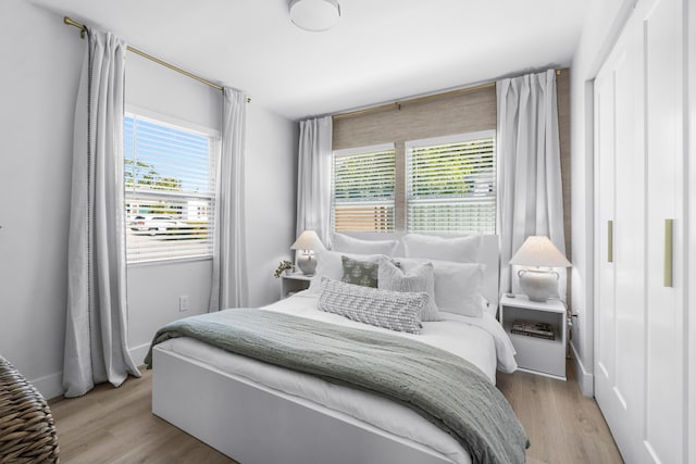 bedroom featuring light wood-type flooring and multiple windows