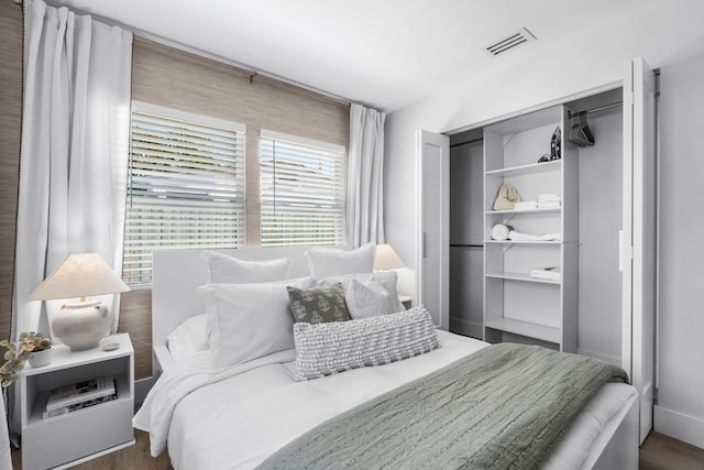 bedroom with dark hardwood / wood-style floors