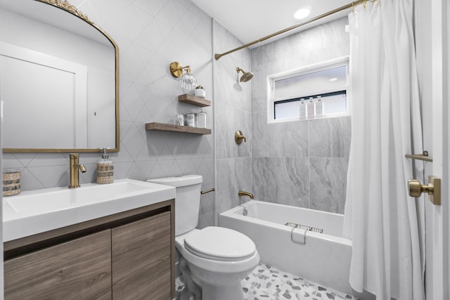 full bathroom featuring vanity, shower / bath combination with curtain, tile walls, and toilet