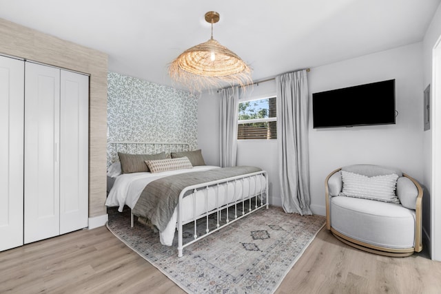 bedroom featuring a closet and light wood-type flooring