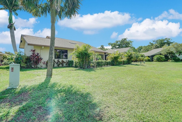 view of front of home featuring a front lawn and stucco siding