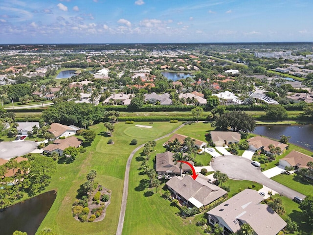 drone / aerial view featuring a residential view, a water view, and golf course view