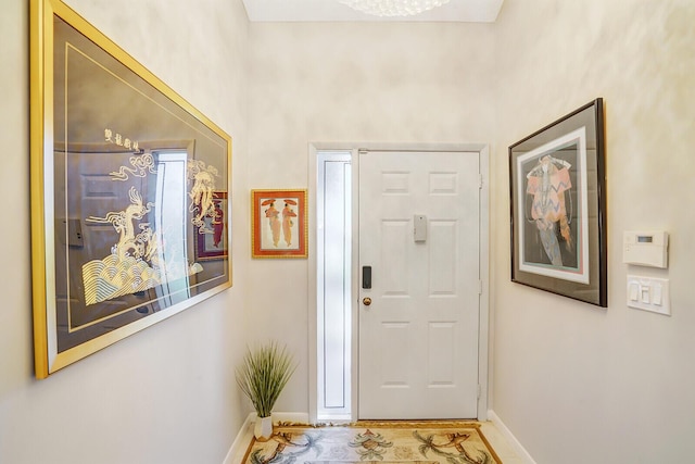 foyer entrance featuring baseboards