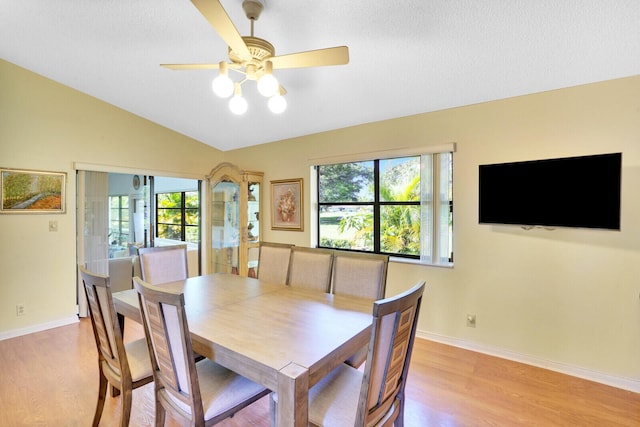 dining area with light wood-type flooring, ceiling fan, and lofted ceiling