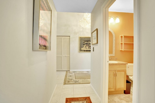 hall with light tile patterned floors and sink