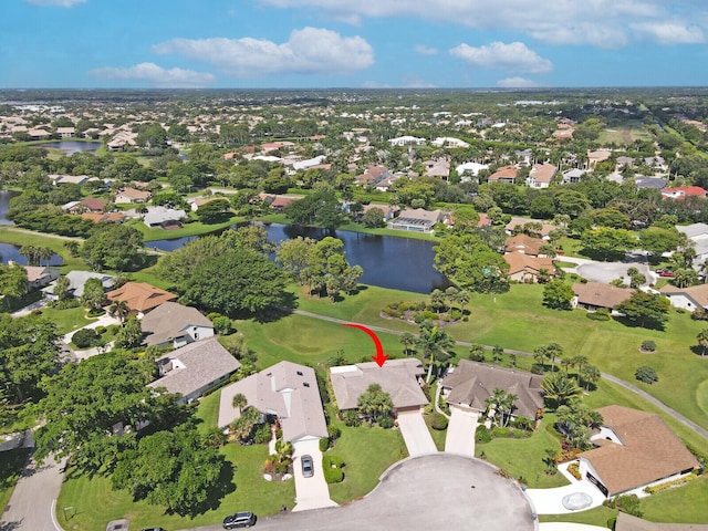 drone / aerial view featuring a residential view and a water view