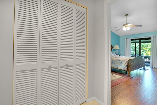 bedroom with light wood-type flooring, ceiling fan, and lofted ceiling