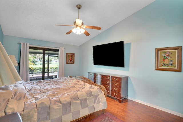 bedroom featuring access to exterior, hardwood / wood-style floors, vaulted ceiling, and ceiling fan