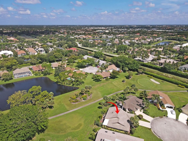 birds eye view of property featuring view of golf course, a water view, and a residential view