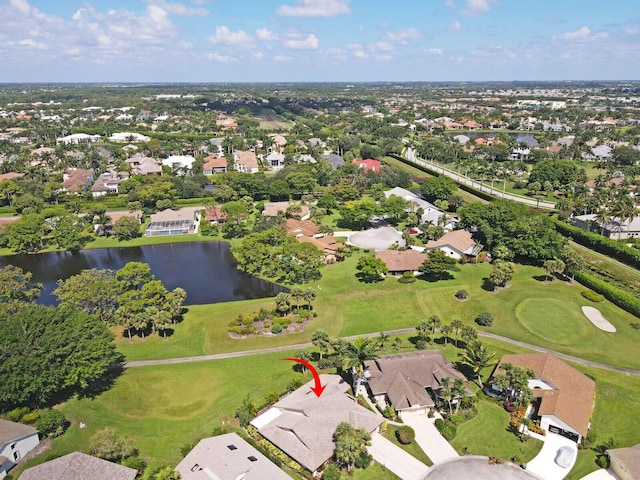 birds eye view of property with a water view, view of golf course, and a residential view