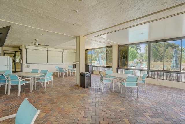 unfurnished sunroom featuring plenty of natural light and ceiling fan