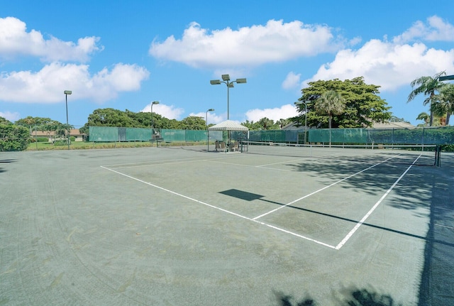 view of tennis court featuring fence