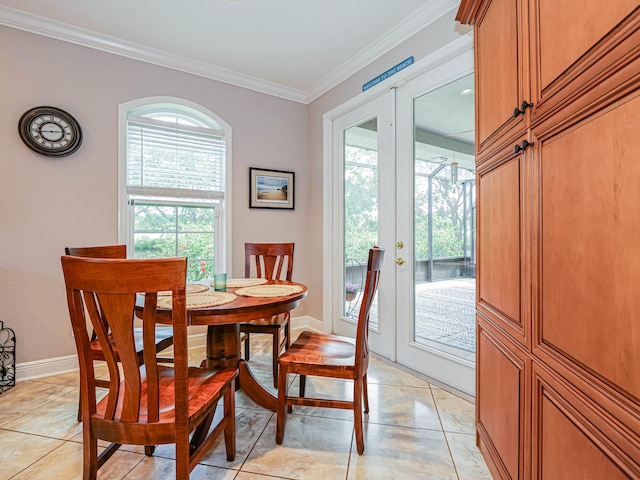 tiled dining room featuring ornamental molding and french doors