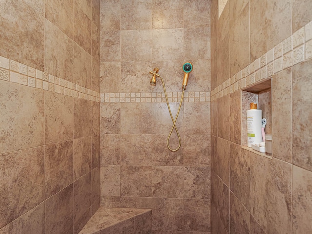 interior details with a tile shower