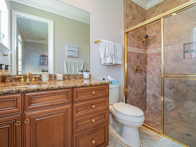 bathroom featuring vanity with extensive cabinet space, toilet, and a shower with door