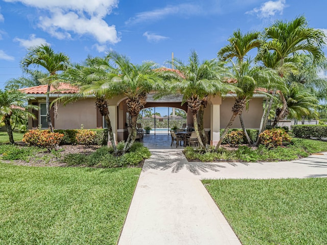 mediterranean / spanish home with a front yard