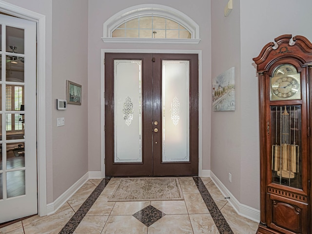 tiled foyer featuring french doors