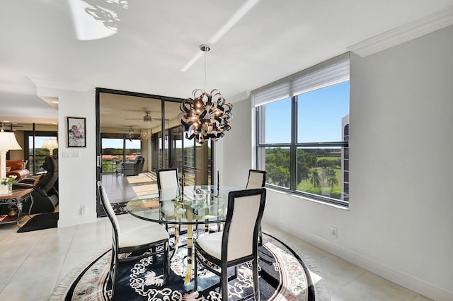 tiled dining room featuring an inviting chandelier, crown molding, and a wealth of natural light